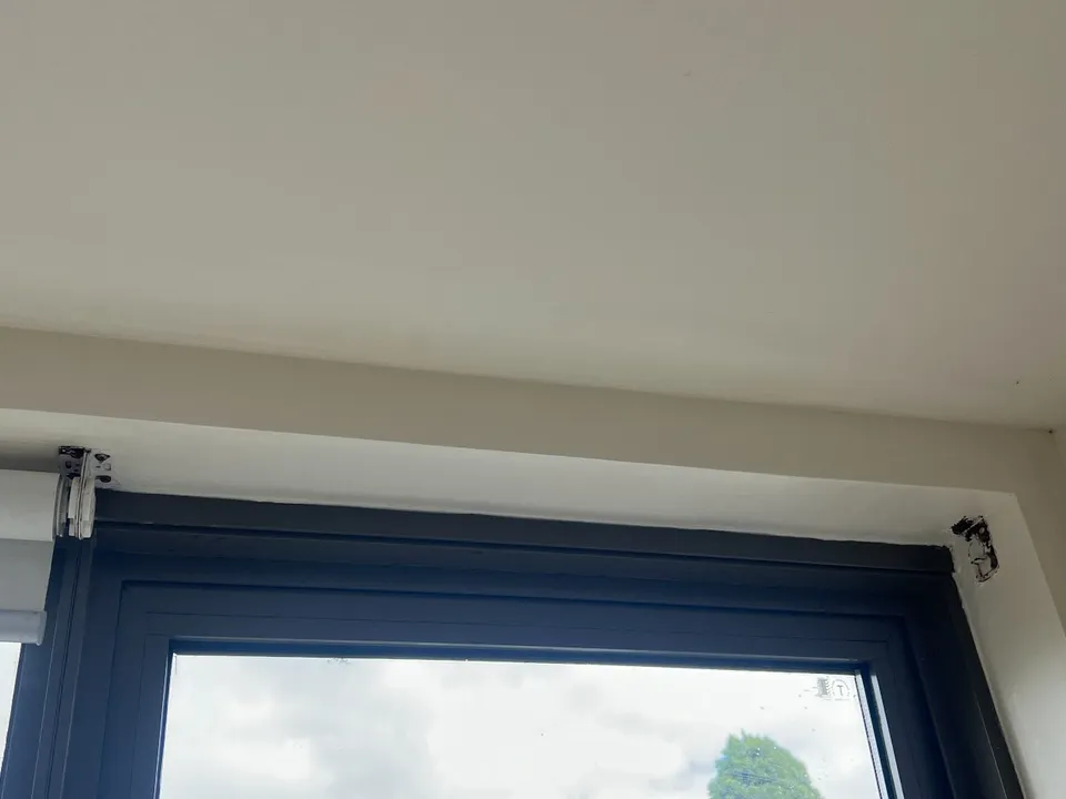 The same window, same blue frame, same catch, same reveal, painted clean and white