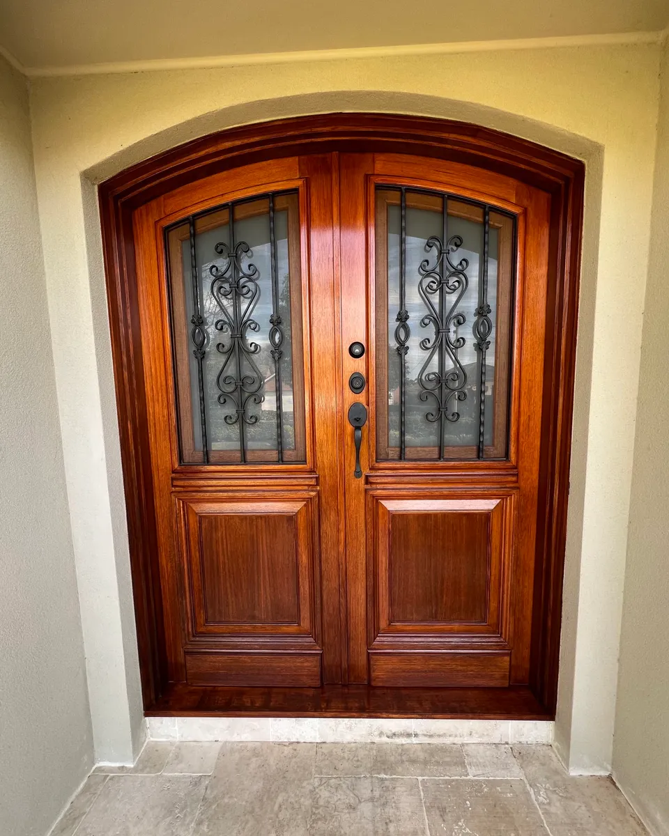 Arched timber double doors, stained and varnished